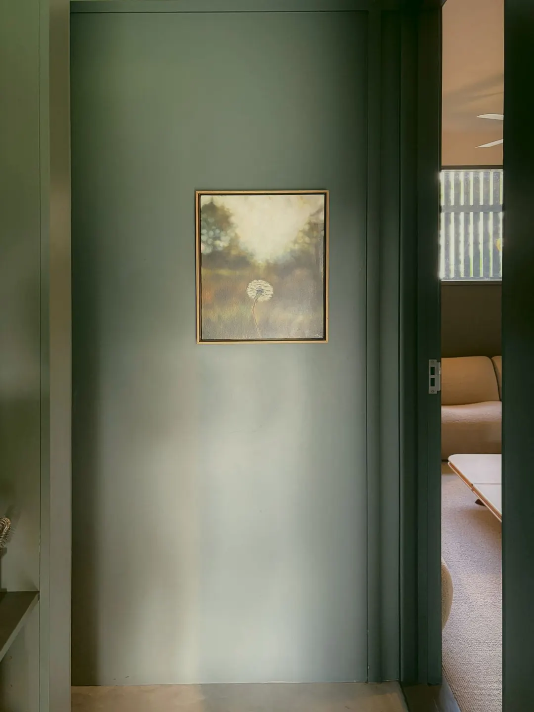 Sage hallway with a framed painting
